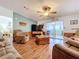Open living room with a view to the sunroom and kitchen at 1559 Nassau Cir, Tavares, FL 32778