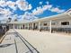 Community pool area with patio furniture and fenced area at 1559 Nassau Cir, Tavares, FL 32778