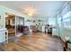 Bright sunroom with wood floors, workspace, and access to living area at 1559 Nassau Cir, Tavares, FL 32778