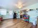 Sunroom with wood floors, ceiling fan, and access to living area at 1559 Nassau Cir, Tavares, FL 32778