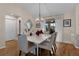 Dining area with a marble table, six chairs, and wood floors at 16846 Se 86Th Deptford Ct, The Villages, FL 32162