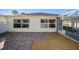 Backyard with stone patio and screened enclosure at 17113 Se 78Th Larchmont Ct, The Villages, FL 32162
