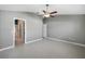 Primary bedroom with ceiling fan and en-suite bathroom access at 17113 Se 78Th Larchmont Ct, The Villages, FL 32162