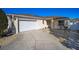 Front view of a single-story house with a two-car garage and landscaped yard at 17113 Se 78Th Larchmont Ct, The Villages, FL 32162