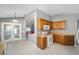 Kitchen with wood cabinets, gas range, and tile floor at 17113 Se 78Th Larchmont Ct, The Villages, FL 32162