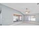 Bright living room with vaulted ceiling, ceiling fan, and large windows at 17113 Se 78Th Larchmont Ct, The Villages, FL 32162