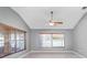 Bright living room with vaulted ceiling, ceiling fan, and large windows at 17113 Se 78Th Larchmont Ct, The Villages, FL 32162