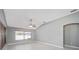 Bright living room with vaulted ceiling, ceiling fan, and large windows at 17113 Se 78Th Larchmont Ct, The Villages, FL 32162