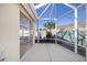 Screened patio with sliding glass doors and view of garden at 17113 Se 78Th Larchmont Ct, The Villages, FL 32162
