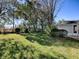 A spacious backyard featuring lush grass, mature trees, and a privacy fence providing an ideal outdoor retreat at 17242 Se 94Th Coults Cir, The Villages, FL 32162