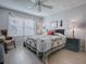 Main bedroom with a ceiling fan and large bed at 17242 Se 94Th Coults Cir, The Villages, FL 32162