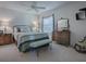 A cozy bedroom featuring soft carpeting, a comfortable bed, and stylish, traditional furniture, all bathed in soft, natural light at 17242 Se 94Th Coults Cir, The Villages, FL 32162