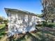 House exterior showcasing a screened porch and well-maintained yard at 17242 Se 94Th Coults Cir, The Villages, FL 32162