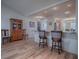 Welcoming foyer with wood floors, a glass front door, a decorative table, and elegant accents at 17242 Se 94Th Coults Cir, The Villages, FL 32162