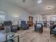 Open-concept living room with wood floors, lots of seating, and an open access to the kitchen at 17242 Se 94Th Coults Cir, The Villages, FL 32162