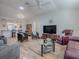 Open concept living room with hardwood floors and a view into the kitchen at 17242 Se 94Th Coults Cir, The Villages, FL 32162