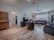 Spacious living room with wood floors, vaulted ceilings, lots of seating, and natural light at 17242 Se 94Th Coults Cir, The Villages, FL 32162