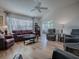 Bright living room featuring wood floors, neutral paint, comfortable seating, and lots of natural light at 17242 Se 94Th Coults Cir, The Villages, FL 32162