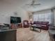 Comfortable living room featuring wood floors, a vaulted ceiling, lots of seating, and natural light at 17242 Se 94Th Coults Cir, The Villages, FL 32162