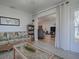 Sunroom with tiled floor, wicker furniture, and view into the living room at 17242 Se 94Th Coults Cir, The Villages, FL 32162