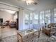 Comfortable sunroom featuring wicker furniture, a glass coffee table, and an abundance of natural light at 17242 Se 94Th Coults Cir, The Villages, FL 32162
