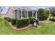 Landscaped backyard with a screened patio and grill area at 17466 Se 75Th Coachman Ct, The Villages, FL 32162