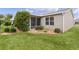 Landscaped backyard with a screened patio and grassy area at 17466 Se 75Th Coachman Ct, The Villages, FL 32162