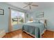 Bright bedroom with a ceiling fan and large window at 17466 Se 75Th Coachman Ct, The Villages, FL 32162