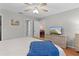 Bedroom with a dresser, ceiling fan, and view of the dining room at 17466 Se 75Th Coachman Ct, The Villages, FL 32162