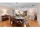 Bright dining room with wood floors and seating for six at 17466 Se 75Th Coachman Ct, The Villages, FL 32162