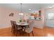 Dining room features wood floors and view into kitchen at 17466 Se 75Th Coachman Ct, The Villages, FL 32162