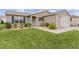 Tan house with a walkway and landscaping at 17466 Se 75Th Coachman Ct, The Villages, FL 32162