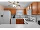 Kitchen with oak cabinets, tile backsplash, and breakfast bar at 17466 Se 75Th Coachman Ct, The Villages, FL 32162