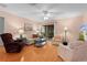 Living room with hardwood floors, a sofa, and a TV at 17466 Se 75Th Coachman Ct, The Villages, FL 32162