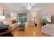 Living room with hardwood floors and patio access at 17466 Se 75Th Coachman Ct, The Villages, FL 32162