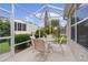 Enjoy relaxing in this screened patio, featuring a table and chairs, perfect for outdoor dining at 17466 Se 75Th Coachman Ct, The Villages, FL 32162