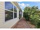Brick paved walkway alongside the house leading to a screened patio area at 1757 Landrum Ln, The Villages, FL 32162