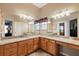 Large bathroom with dual vanities and granite countertops at 1757 Landrum Ln, The Villages, FL 32162