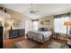 Main bedroom with king-size bed, ample floor space, and wood flooring at 1757 Landrum Ln, The Villages, FL 32162