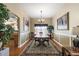 Bright dining room features a wood table, chandelier, and decorative rug at 1757 Landrum Ln, The Villages, FL 32162