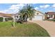 Beautiful home exterior with landscaping and two-car garage at 1757 Landrum Ln, The Villages, FL 32162