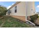 Tan vinyl-sided house with landscaping, a paved driveway, and a two-car garage at 1757 Landrum Ln, The Villages, FL 32162