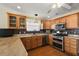 Modern kitchen with granite countertops, stainless steel appliances, and wood cabinets at 1757 Landrum Ln, The Villages, FL 32162