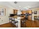 L-shaped kitchen with granite countertops and stainless steel appliances at 1757 Landrum Ln, The Villages, FL 32162