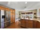 Kitchen features stainless steel appliances, granite counters, and wood cabinets at 1757 Landrum Ln, The Villages, FL 32162