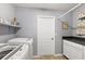 Laundry room with washer, dryer, and built-in cabinets at 1757 Landrum Ln, The Villages, FL 32162