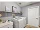 Laundry room with washer, dryer, shelving, and countertop at 1757 Landrum Ln, The Villages, FL 32162