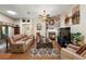 Spacious living room with a fireplace, hardwood floors, and comfy seating at 1757 Landrum Ln, The Villages, FL 32162