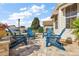 Relaxing patio with blue Adirondack chairs and brick pavers at 1757 Landrum Ln, The Villages, FL 32162