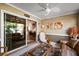 Bright sunroom with comfy seating and glass sliding doors at 1757 Landrum Ln, The Villages, FL 32162
